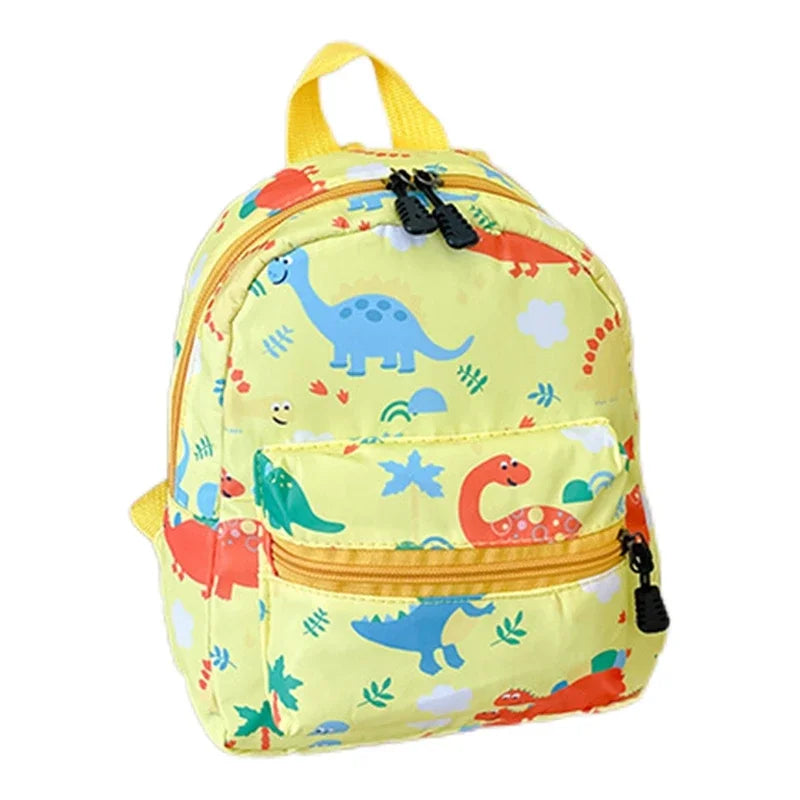 A yellow kids backpack featuring a cute dinosaur and unicorn pattern.