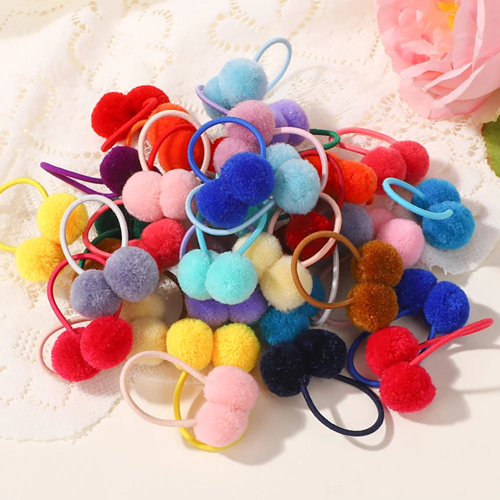 A collection of colorful double plush elastic hair bands in various shades including red, blue, purple, and yellow.