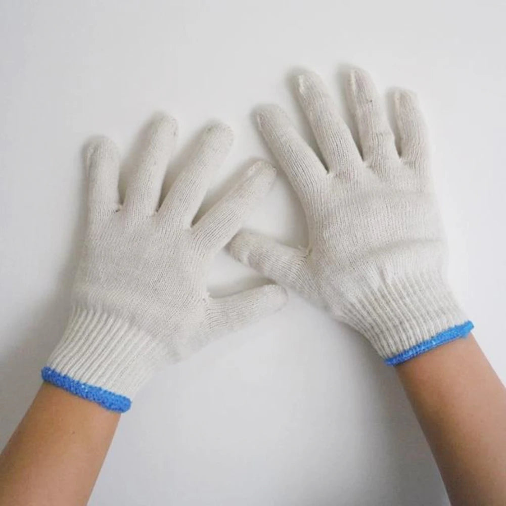 A pair of white cotton thread work gloves worn on a person's hands.