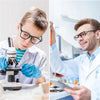 A young man in a lab coat is using a microscope to examine a sample.