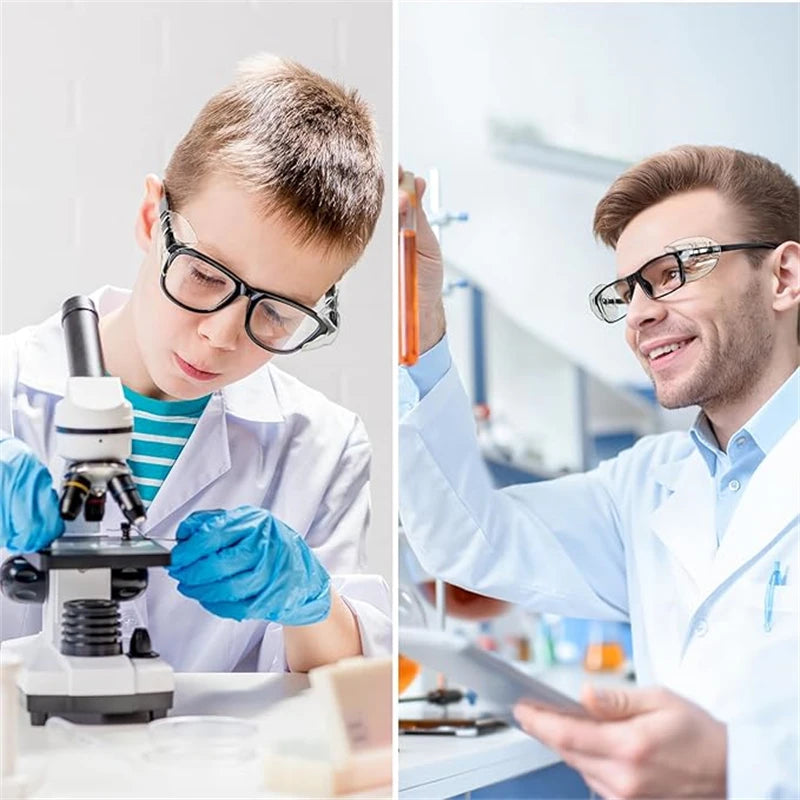 A young man in a lab coat is using a microscope to examine a sample.