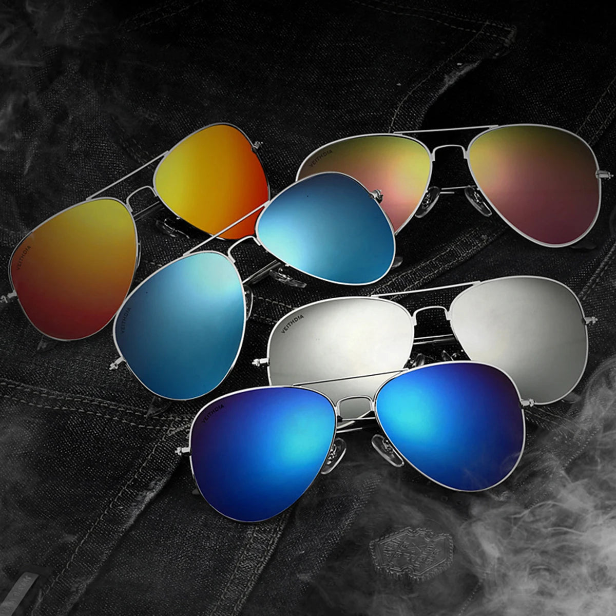 A collection of men's aviator sunglasses in various colored lenses and gold/silver frames displayed on a dark, smoky backgrou