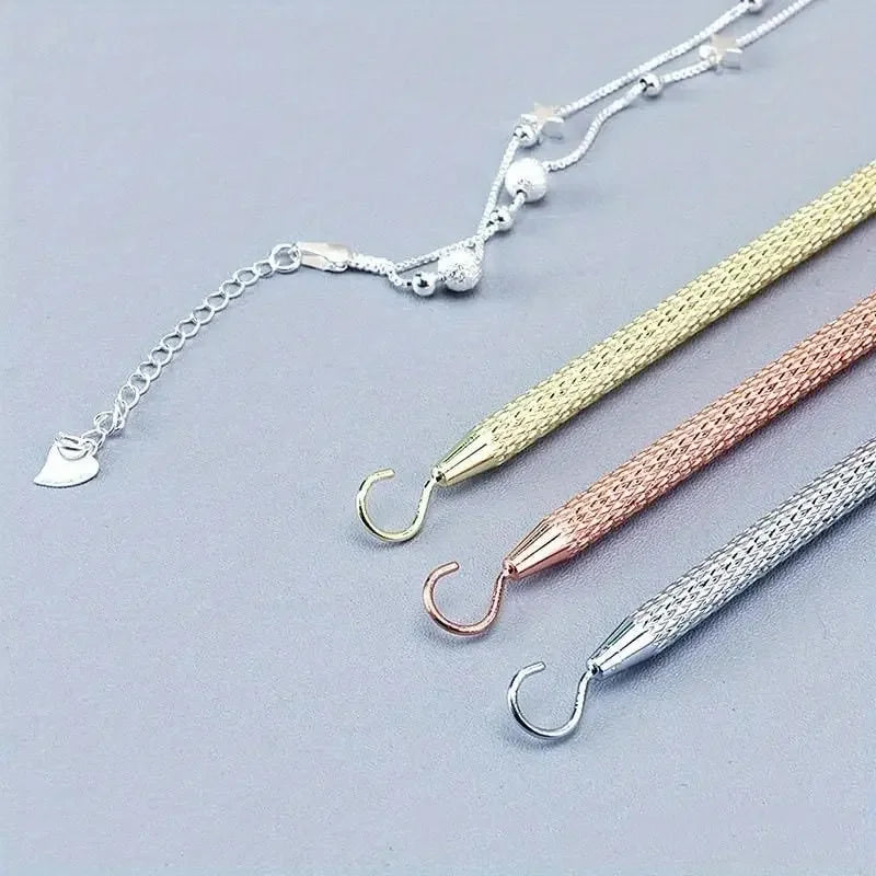 A collection of precision jewelry tools for clasps and closures, including various types of pliers and cutters.
