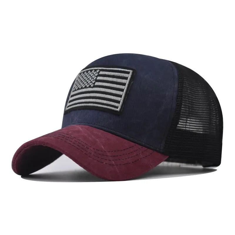 A dark blue tactical baseball cap featuring a distressed American flag patch and a mesh back.