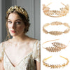 A woman wearing a gold leaf headband for bridal or party, featuring delicate foliage.