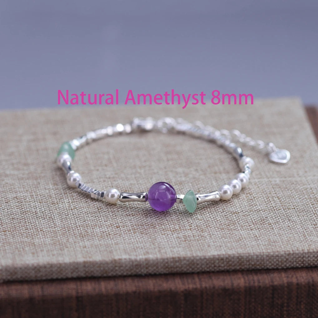 Sterling silver double heart charm bracelet featuring amethyst and green gemstone beads
