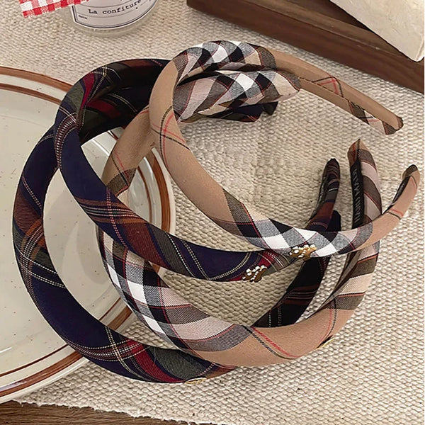 A collection of British plaid sponge headbands in various muted tones and patterns.