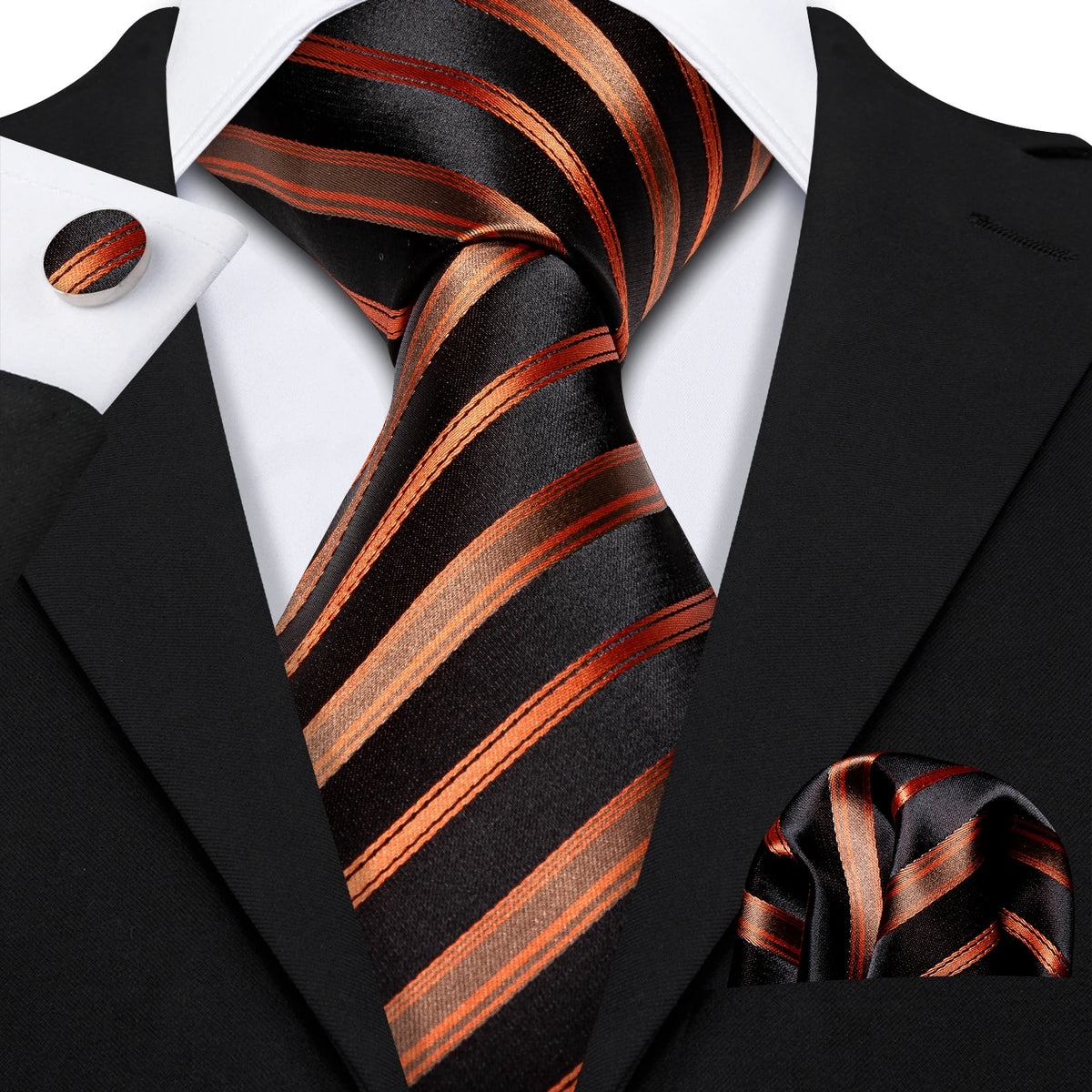 A black suit jacket and a striped orange and black silk jacquard tie displayed against a white shirt.