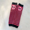 Black and pink striped fingerless socks featuring skull designs for Y2K grunge accessories
