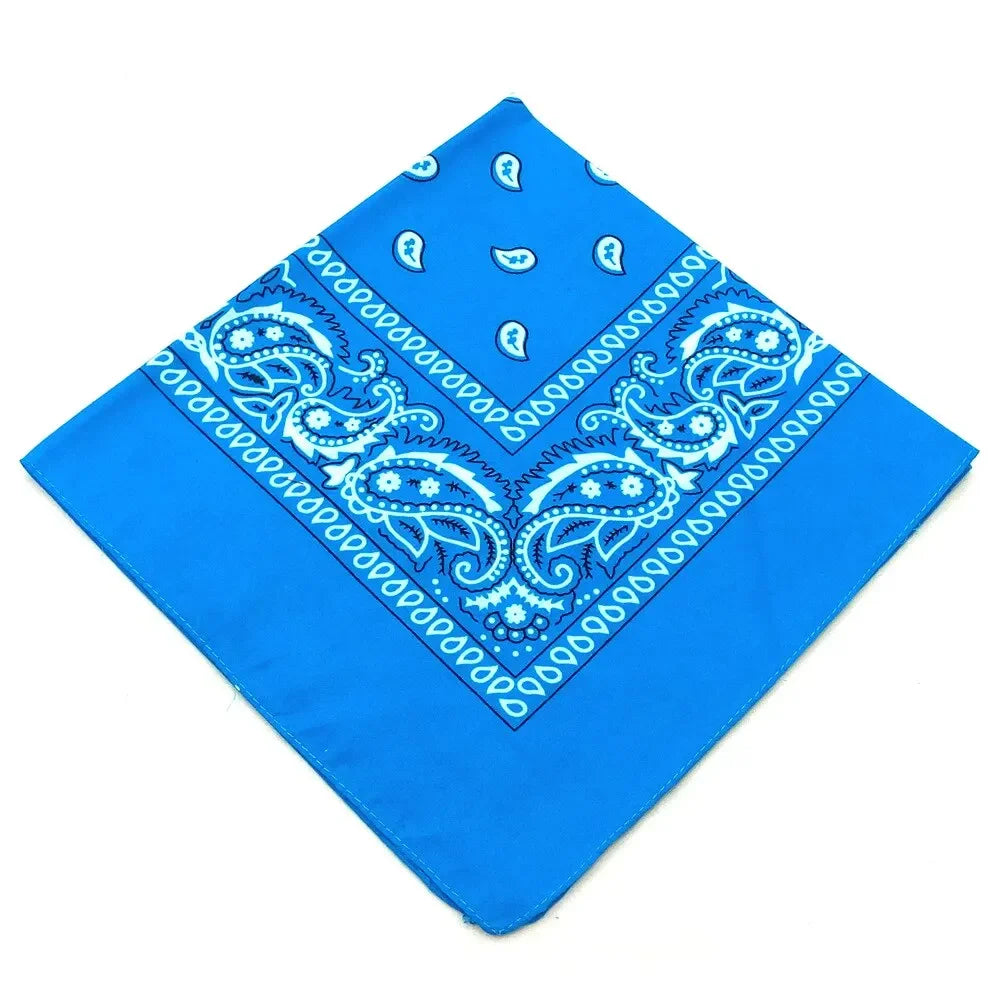 A bright blue bandana featuring an intricate white bohemian print design.