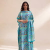 A woman models an elegant long silk blend cover-up robe dress featuring a vibrant blue and teal pattern with multicolored cir
