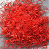 A pile of bright red disposable hair scrunchies for ponytail holders.