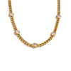 Gold-toned charm necklace featuring small clear cubic zirconia stones on a chain.