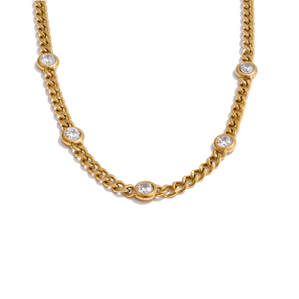 Gold-toned charm necklace featuring small clear cubic zirconia stones on a chain.