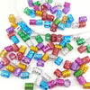 A collection of multicolor dreadlock hair rings and beads in various shades including purple, green, blue, and gold.