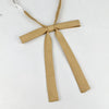 A beige fabric ribbon tied in a butterfly shape, used as a tie set for students.