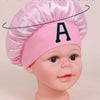 Pink A-Z letter sleep cap for kids shown on a baby model, with weight specifications.