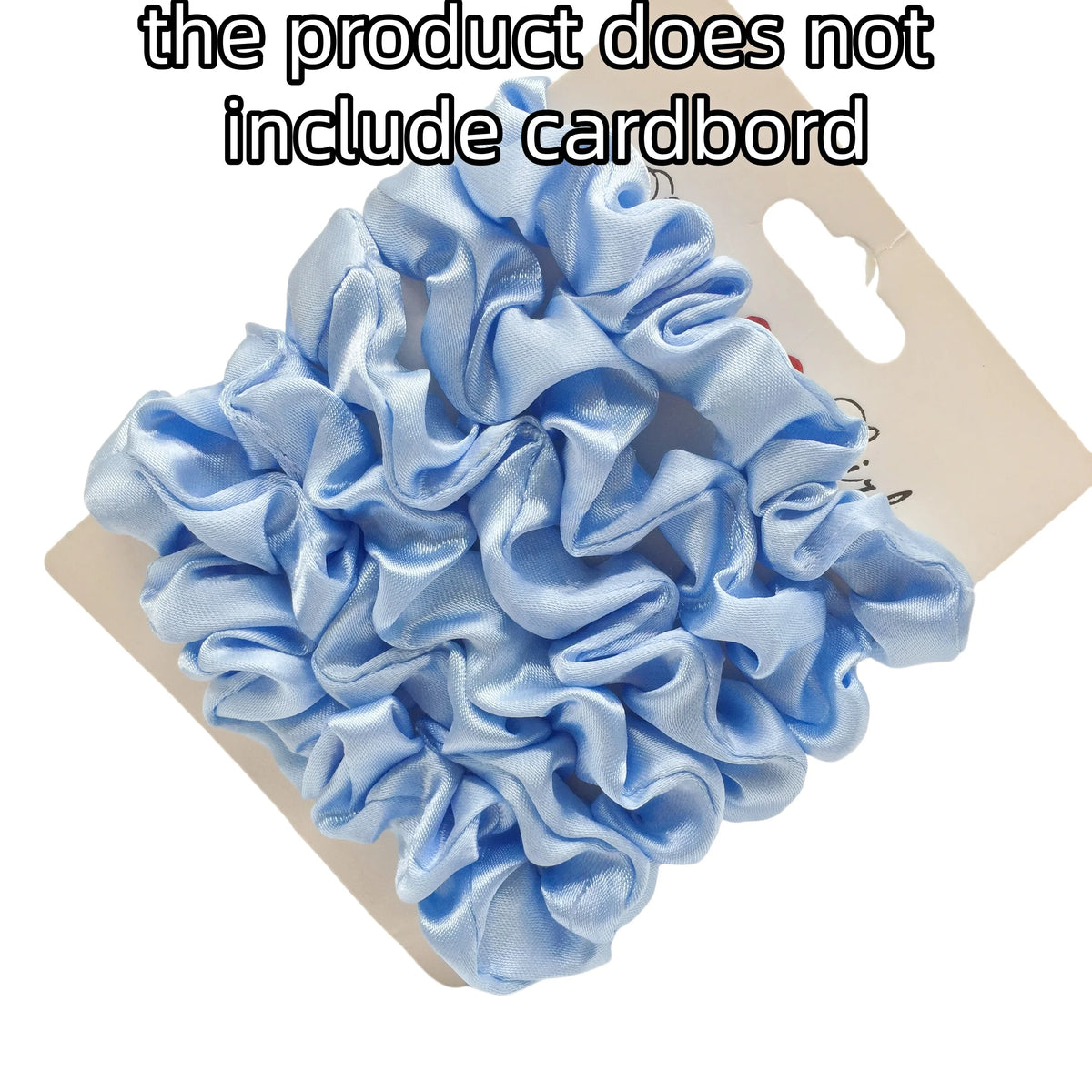 A pile of light blue satin hair scrunchies is shown on a cardboard backing.