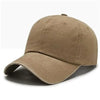 A tan baseball cap shown from the side, featuring a curved brim and a mesh back.