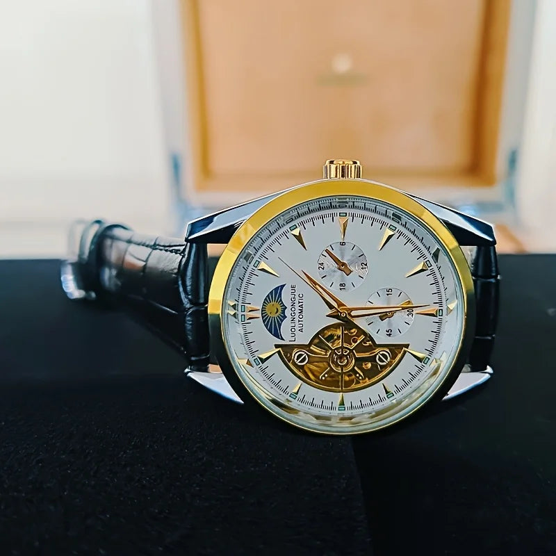 A close-up shot of a gold-toned luxury automatic mechanical men's wristwatch with a dark strap, resting on a black surface.