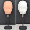 A professional mannequin wig stand showing a light peach-colored head and a white head on a black display base.