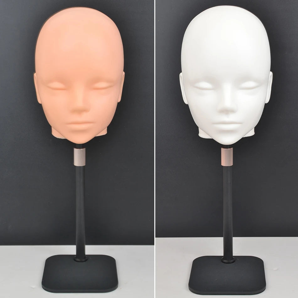 A professional mannequin wig stand showing a light peach-colored head and a white head on a black display base.