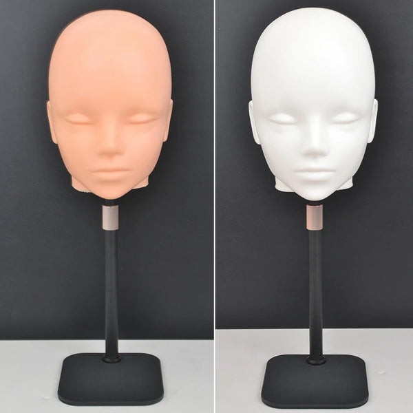 A professional mannequin wig stand showing a light peach-colored head and a white head on a black display base.