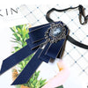 A dark navy blue rhinestone bow tie neck tie with a silver embellishment displayed on a white background.