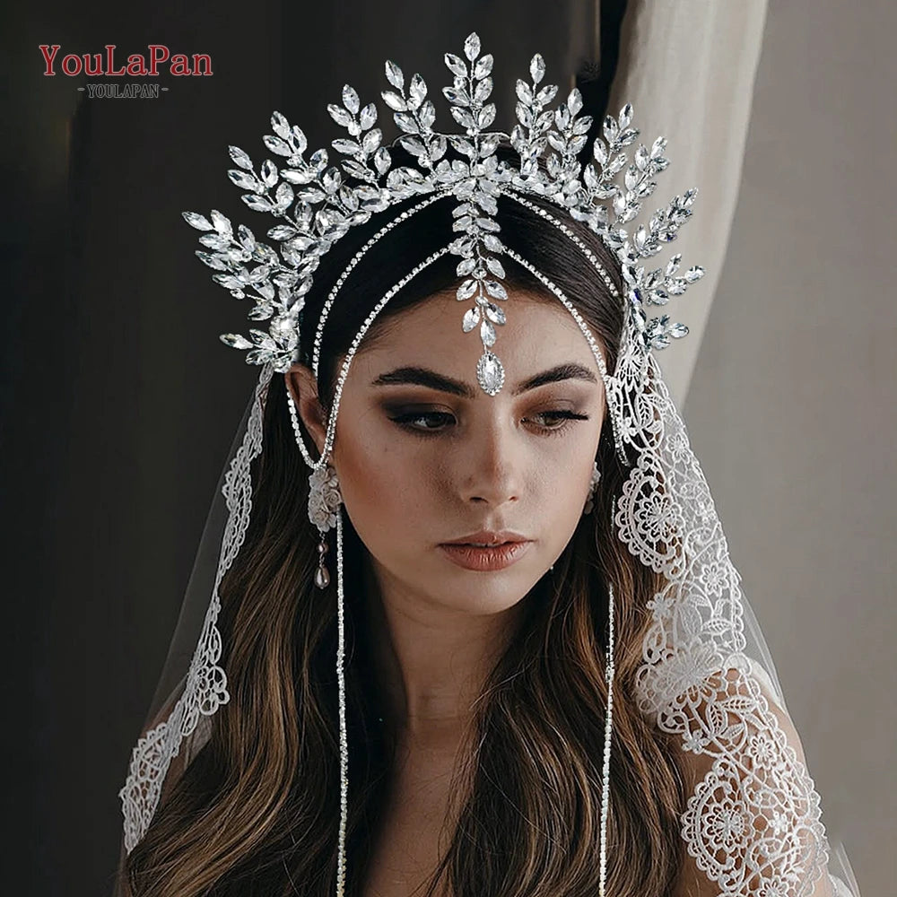 A woman wearing a sparkling rhinestone bridal crown headband and lace veil.