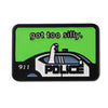 A green enamel pin featuring the text got too silly and a silhouette of a police car.