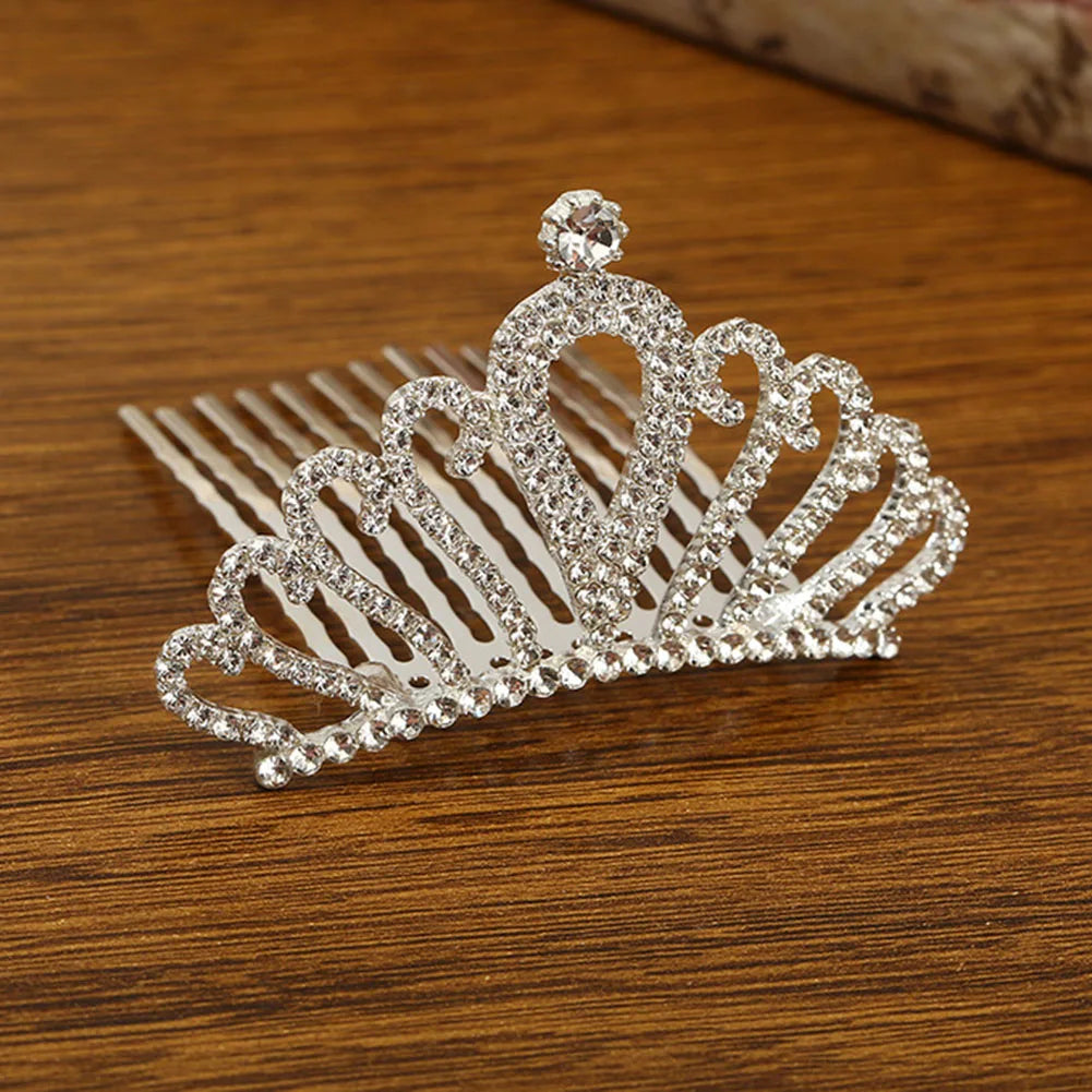 Sparkling crystal princess tiara hair comb for women displayed on a wooden surface