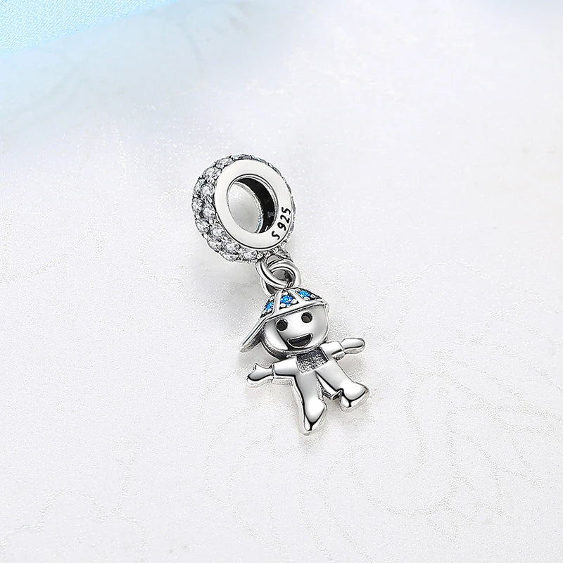 A silver family tree charm jewelry piece featuring a charm of a figure and a circular pendant.