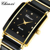 A black and gold fashion wristwatch with a square face and gold-toned band.