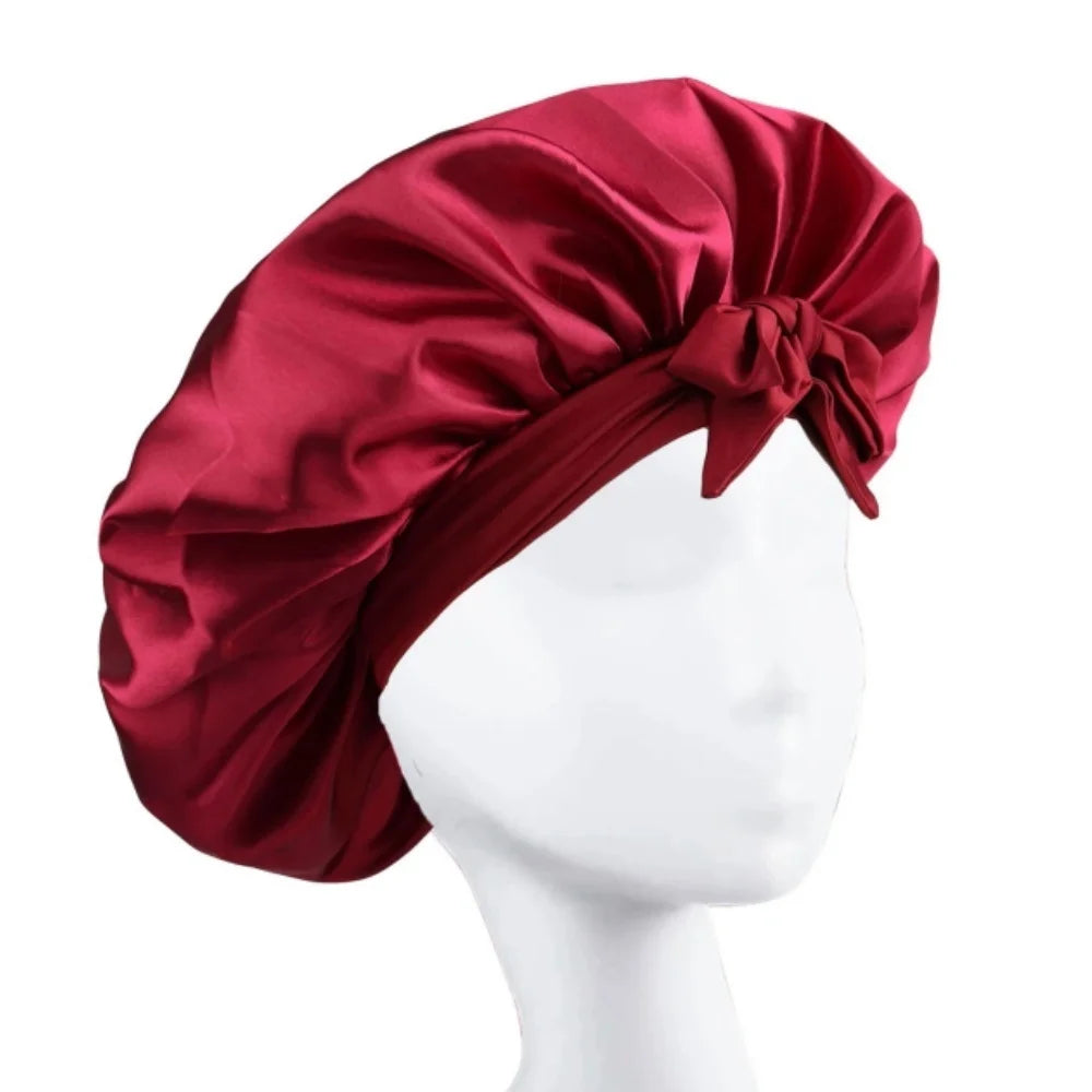 A deep red satin wide-brimmed hair wrap headscarf displayed on a white mannequin.
