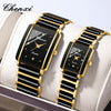 A pair of black and gold ceramic fashion wristwatches displayed on a white box.