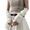 A model wearing fingerless arm warmers and a light top with a pleated skirt.