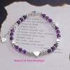 Sterling silver double heart charm bracelet featuring purple amethyst stones and a silver heart pendant