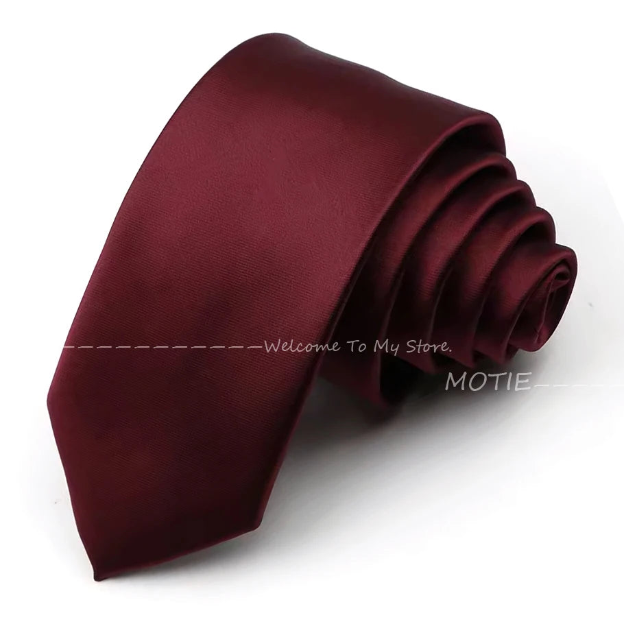A deep burgundy satin neck tie folded and displayed on a white background.