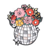 A vintage enamel brooch featuring a bouquet of pink and orange flowers in a gray mosaic pot.