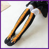 Black socks with orange chicken print detailing on the foot and leg, worn under a black garment.