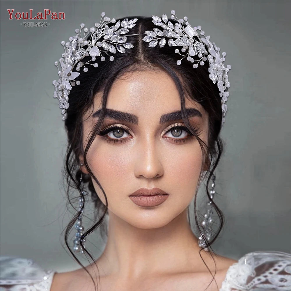 A close-up of a woman wearing a silver crystal bridal headband with delicate floral accents.