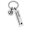 Silver keychain with a black initial B and engraved text Drive Safe I need you here with me