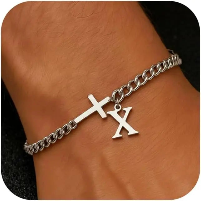 A close-up of a personalized stainless steel cross Cuban chain bracelet worn on a wrist.