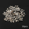 A pile of silver star metal snap hair clips.