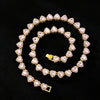 A gold-toned necklace and bracelet set featuring sparkling pink heart-shaped rhinestones.