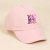 Pink baseball cap featuring a purple unicorn letter design