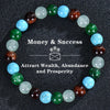 A bracelet made of various colored crystals, including green, blue, and brown, arranged in a circle.