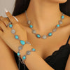 Silver and turquoise beaded necklace and bracelet set worn by a woman