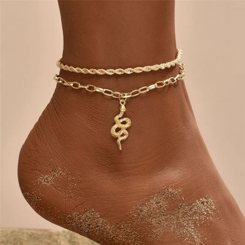 Gold chain anklet bracelet worn on a person's ankle with body glitter