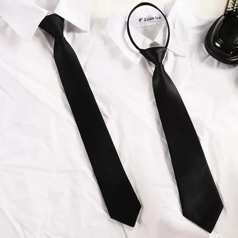 A black clip-on security tie is displayed against a white shirt.